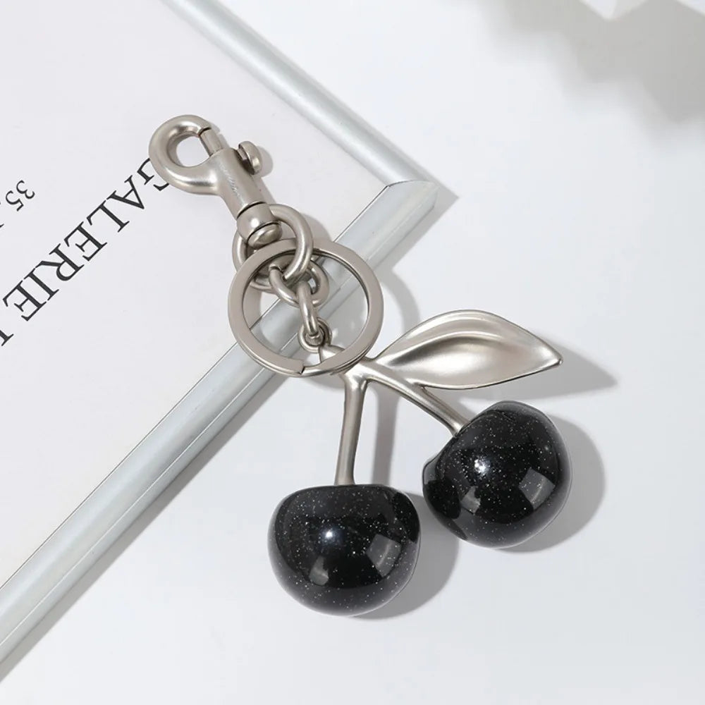 Keychain with black cherries on a white background