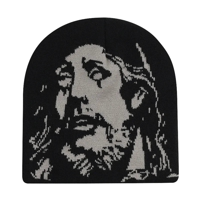 Black beanie with a white embroidered design of a face on a white background