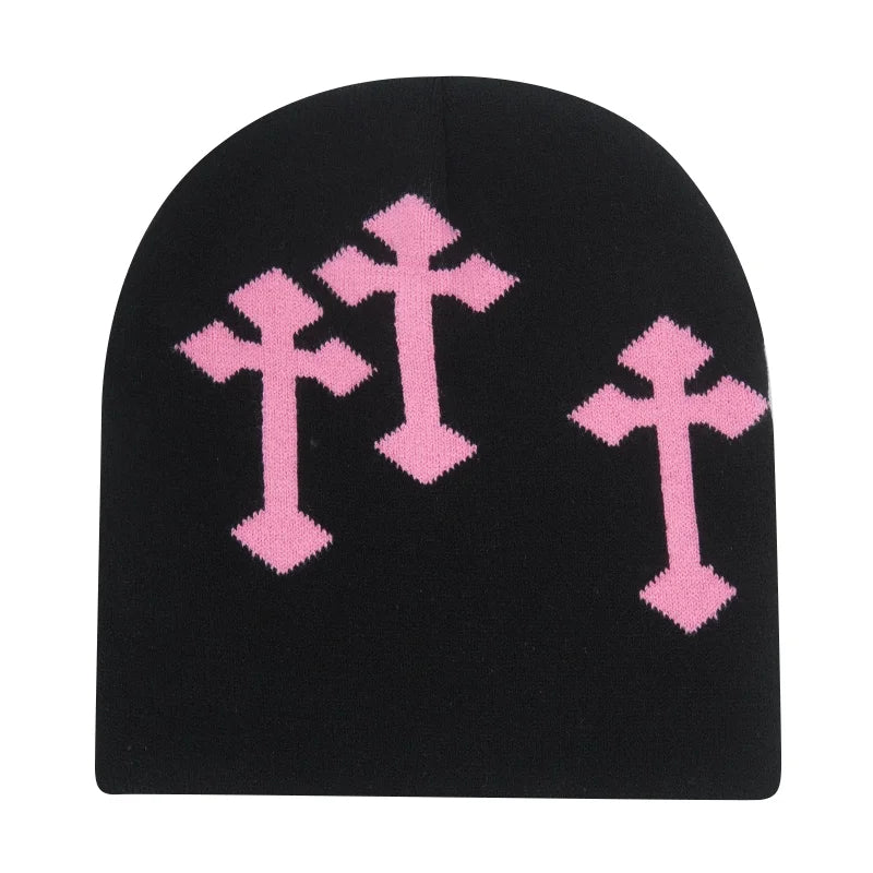 Black beanie with pink cross patterns on a white background