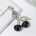 Keychain with black cherries on a white background